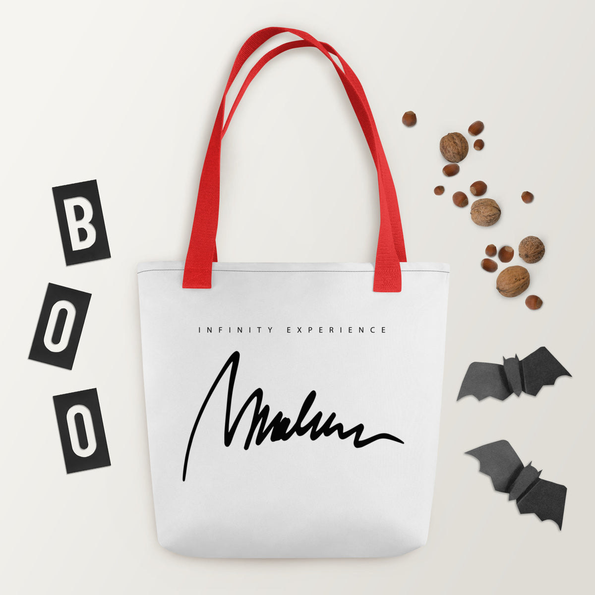 Golden Icon Carry: bolsa blanca con firma negra Marlene en el reverso y asas rojas.