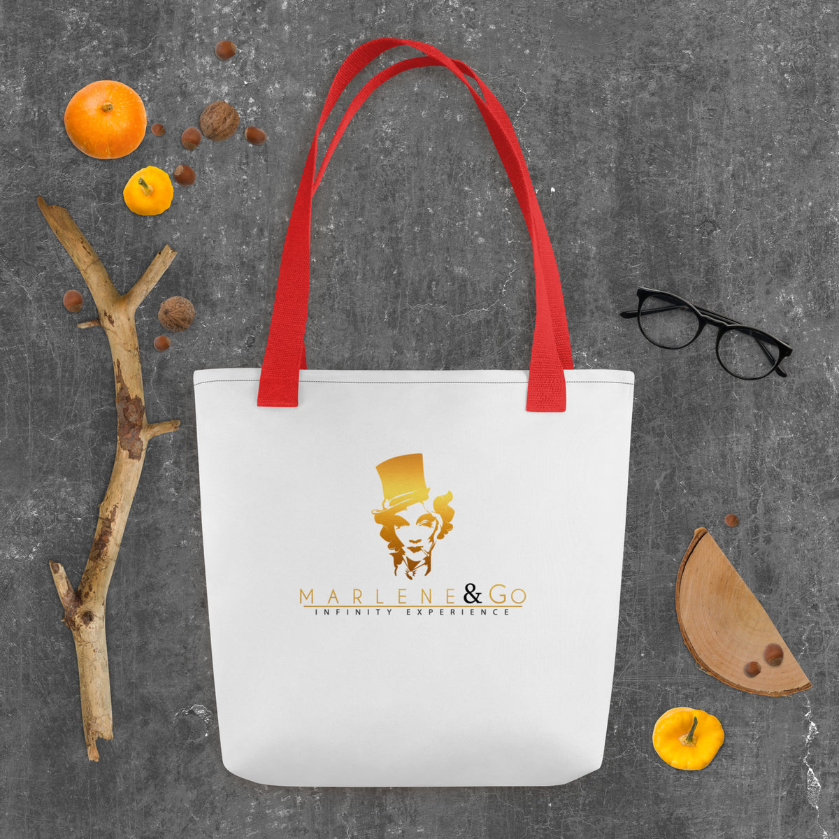 Golden Icon Carry: bolsa blanca con retrato dorado de Marlene y asas rojas, vista frontal.