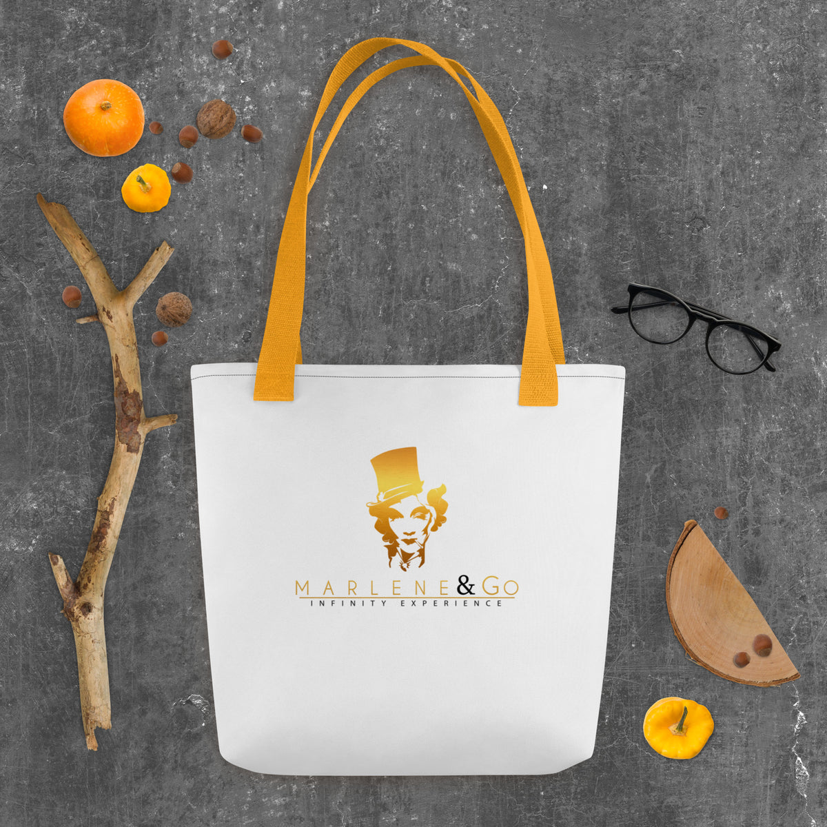 Golden Icon Carry: bolsa blanca con retrato dorado de Marlene y asas amarillas, vista frontal.