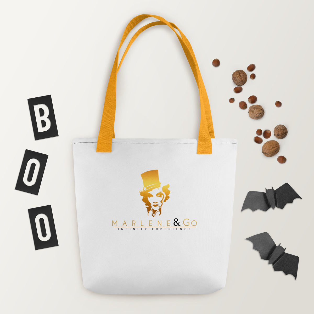 Golden Icon Carry: bolsa blanca con retrato dorado de Marlene y asas amarillas, vista frontal.